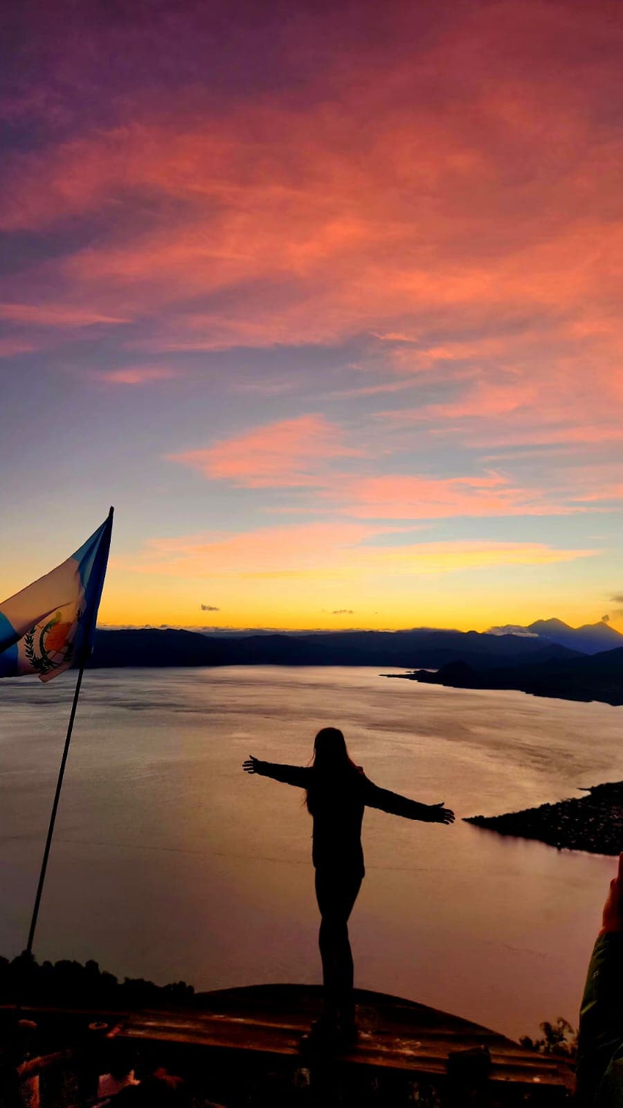 Volcanoes silhouetted against the dawn sky over Lake Atitlán, tour from Panajachel