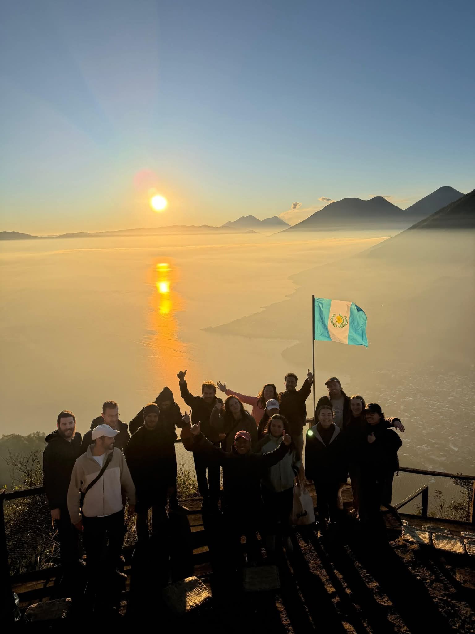 Hikers watching the sunrise at the Rostro Maya viewpoint above Lake Atitlán